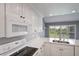 Updated kitchen featuring white cabinets, granite counters, and stainless appliances at 6036 Topsail Rd, Lady Lake, FL 32159