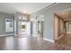 Open living room with plenty of natural light, wood floors, and neutral paint at 6036 Topsail Rd, Lady Lake, FL 32159