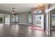 Spacious living room with hardwood floors, featuring an open entrance and a glimpse of the home's exterior at 6036 Topsail Rd, Lady Lake, FL 32159