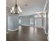 Open-concept living area featuring hardwood floors, elegant lighting, and a welcoming entrance at 6036 Topsail Rd, Lady Lake, FL 32159