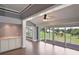 Comfortable living room with wood floors, a ceiling fan, and sliding glass doors to patio at 6036 Topsail Rd, Lady Lake, FL 32159