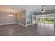 Spacious living room features hardwood floors, a fireplace, and abundant natural light from sliding glass doors at 6036 Topsail Rd, Lady Lake, FL 32159