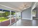 Modern living room with sliding glass doors to a screened-in patio and views at 6036 Topsail Rd, Lady Lake, FL 32159