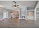 Open-concept living area featuring hardwood floors, a fireplace, and ample space for gatherings at 6036 Topsail Rd, Lady Lake, FL 32159