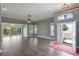 Bright living room with wood floors, many windows, and an open entrance at 6036 Topsail Rd, Lady Lake, FL 32159