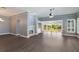 Bright living room showcasing hardwood floors, a fireplace, and large sliding glass doors with an outside view at 6036 Topsail Rd, Lady Lake, FL 32159