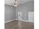 Open main bedroom with wood-look vinyl floors, ceiling fan, and entry into the main bath at 6036 Topsail Rd, Lady Lake, FL 32159