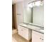 Bathroom featuring a granite-topped double vanity and a tiled shower at 624 Australian Way, Davenport, FL 33897