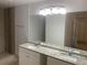 Bathroom with double vanity, granite countertops, and tiled shower area at 624 Australian Way, Davenport, FL 33897