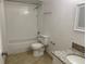 Clean bathroom with tiled shower-tub combination and granite countertop sink at 624 Australian Way, Davenport, FL 33897