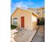 Charming yellow home with a red front door and well-maintained landscaping at 624 Australian Way, Davenport, FL 33897