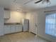 Kitchenette with white cabinets, granite counters, and modern appliances at 624 Australian Way, Davenport, FL 33897