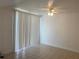Bright living room with neutral tile flooring and vertical blinds for natural light at 624 Australian Way, Davenport, FL 33897