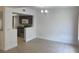 Open floor plan with tile flooring, connecting the living area to the kitchen with stainless appliances at 624 Australian Way, Davenport, FL 33897