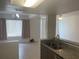 Bright, tiled living space featuring a breakfast bar that connects it to the kitchen area at 624 Australian Way, Davenport, FL 33897