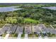 Aerial view of a residential community with houses, streets, green spaces, agricultural field and a lake at 6946 Perch Hammock Loop, Groveland, FL 34736