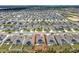 An aerial view highlighting a home with a defined backyard space in a solar panel neighborhood at 6946 Perch Hammock Loop, Groveland, FL 34736