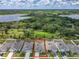 Aerial view of a residential community with houses, streets, green spaces, agricultural field and a lake at 6946 Perch Hammock Loop, Groveland, FL 34736
