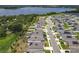 Aerial view showcasing homes with solar panels and a beautiful lake backdrop in the neighborhood at 6946 Perch Hammock Loop, Groveland, FL 34736