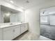 Bathroom featuring double sinks, white cabinets, and tile floors at 6946 Perch Hammock Loop, Groveland, FL 34736