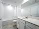 Bright bathroom featuring a shower-tub combo, large mirror, and modern vanity with white cabinets at 6946 Perch Hammock Loop, Groveland, FL 34736
