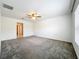 Spacious bedroom with ceiling fan and carpet floors at 6946 Perch Hammock Loop, Groveland, FL 34736