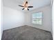 Simple bedroom with gray carpet, white walls, and a window, providing a blank canvas for personalization at 6946 Perch Hammock Loop, Groveland, FL 34736
