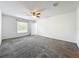 Bedroom offers a ceiling fan, carpet floors, and a window at 6946 Perch Hammock Loop, Groveland, FL 34736