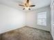 Neutral bedroom featuring plush carpet, ceiling fan, window, and closet at 6946 Perch Hammock Loop, Groveland, FL 34736