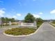 Trinity Lakes entrance sign with stone accents and vibrant floral landscaping creating a welcoming scene at 6946 Perch Hammock Loop, Groveland, FL 34736