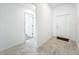 Bright and spacious entryway with neutral tile flooring and a white front door, perfect for a modern home at 6946 Perch Hammock Loop, Groveland, FL 34736