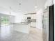 Open kitchen with gray countertops, pendant lights and stainless steel appliances at 6946 Perch Hammock Loop, Groveland, FL 34736