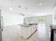 Kitchen island offers a double sink and space for dining in the open concept kitchen at 6946 Perch Hammock Loop, Groveland, FL 34736