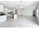Kitchen with center island features tile floors and stainless steel appliances at 6946 Perch Hammock Loop, Groveland, FL 34736