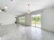 Light-filled living room with sliding glass doors and backyard views at 6946 Perch Hammock Loop, Groveland, FL 34736