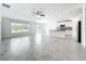 Open-concept living space featuring tile floors, a kitchen, and natural light at 6946 Perch Hammock Loop, Groveland, FL 34736