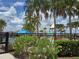 Community pool area featuring palm trees, colorful slides, and a splash pad for Gathering fun at 6946 Perch Hammock Loop, Groveland, FL 34736