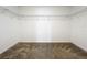 A walk-in closet with carpeted floor and wire shelving for organized storage at 6946 Perch Hammock Loop, Groveland, FL 34736