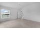 Bedroom with neutral carpet and white walls with a sliding glass door to the outside at 6949 Minchew Cir, The Villages, FL 34762