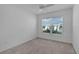 Bright bedroom with a ceiling fan and a large window overlooking the neighborhood at 6949 Minchew Cir, The Villages, FL 34762
