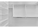 Walk-in closet with white shelving and railing for hanging clothes and storage space at 6949 Minchew Cir, The Villages, FL 34762