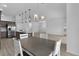 Open concept view of the dining room, kitchen and living room with light-colored floors at 6949 Minchew Cir, The Villages, FL 34762