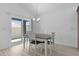 Bright dining room with sliding glass doors and modern chandelier at 6949 Minchew Cir, The Villages, FL 34762