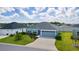 Charming single-story home with a well-manicured lawn and an attached two-car garage at 6949 Minchew Cir, The Villages, FL 34762