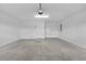 Spacious, clean garage with a neutral painted floor and white walls at 6949 Minchew Cir, The Villages, FL 34762