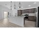 Kitchen with stainless steel appliances, stone countertops, and view into dining area at 6949 Minchew Cir, The Villages, FL 34762