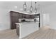 Modern kitchen with stainless steel appliances, stone countertops and kitchen island at 6949 Minchew Cir, The Villages, FL 34762