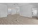 Bright living room with an open layout and access to the dining room, light-colored floors at 6949 Minchew Cir, The Villages, FL 34762