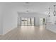 Bright living room with sliding glass doors, ceiling fan and open floor plan at 6949 Minchew Cir, The Villages, FL 34762
