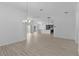 Spacious and open living room with modern light fixtures, and light-colored floors at 6949 Minchew Cir, The Villages, FL 34762